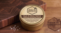 Jar of Gun & Bow Salve from Hive to Hardwood on a wooden surface