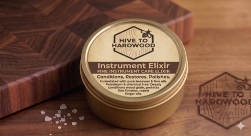 Jar of 'Hive to Hardwood' Instrument Elixir on a wooden surface